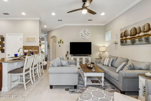 a living room with furniture a rug and a chandelier
