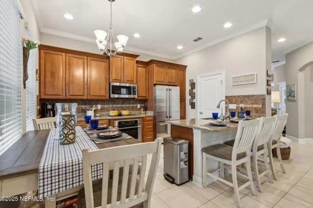 a bathroom with a granite countertop double vanity sink and a mirror
