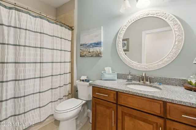 a view of a yard with plants and large trees