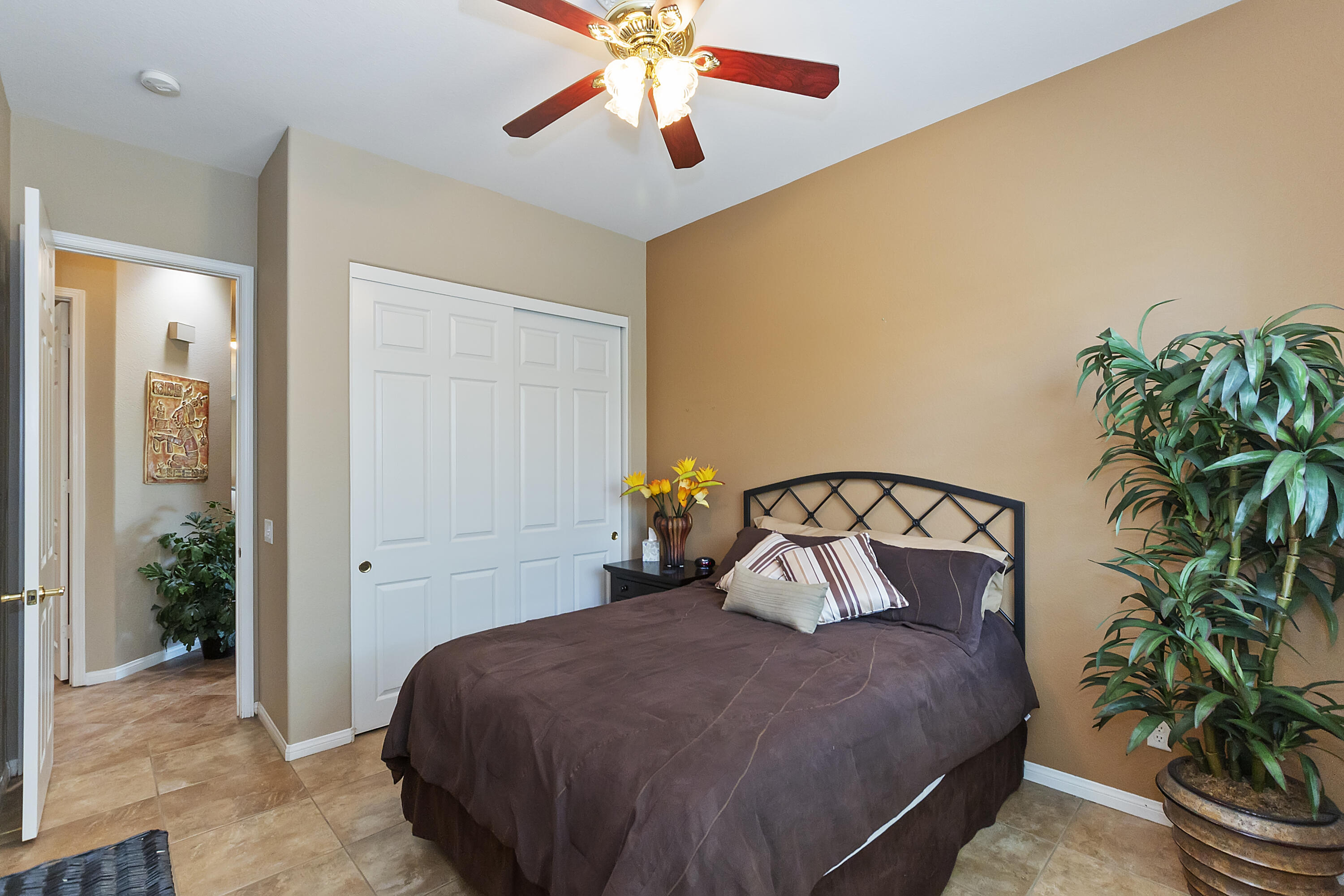 43328 Bordeaux Drive La Quinta, CA 92253 - Photo 17 of 38 a bedroom with a bed and a potted plant