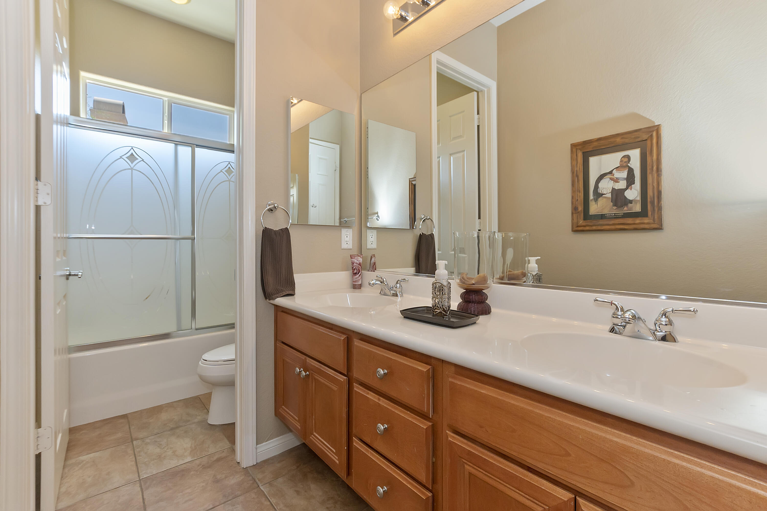 43328 Bordeaux Drive La Quinta, CA 92253 - Photo 18 of 38 a bathroom with a double vanity sink toilet and a mirror