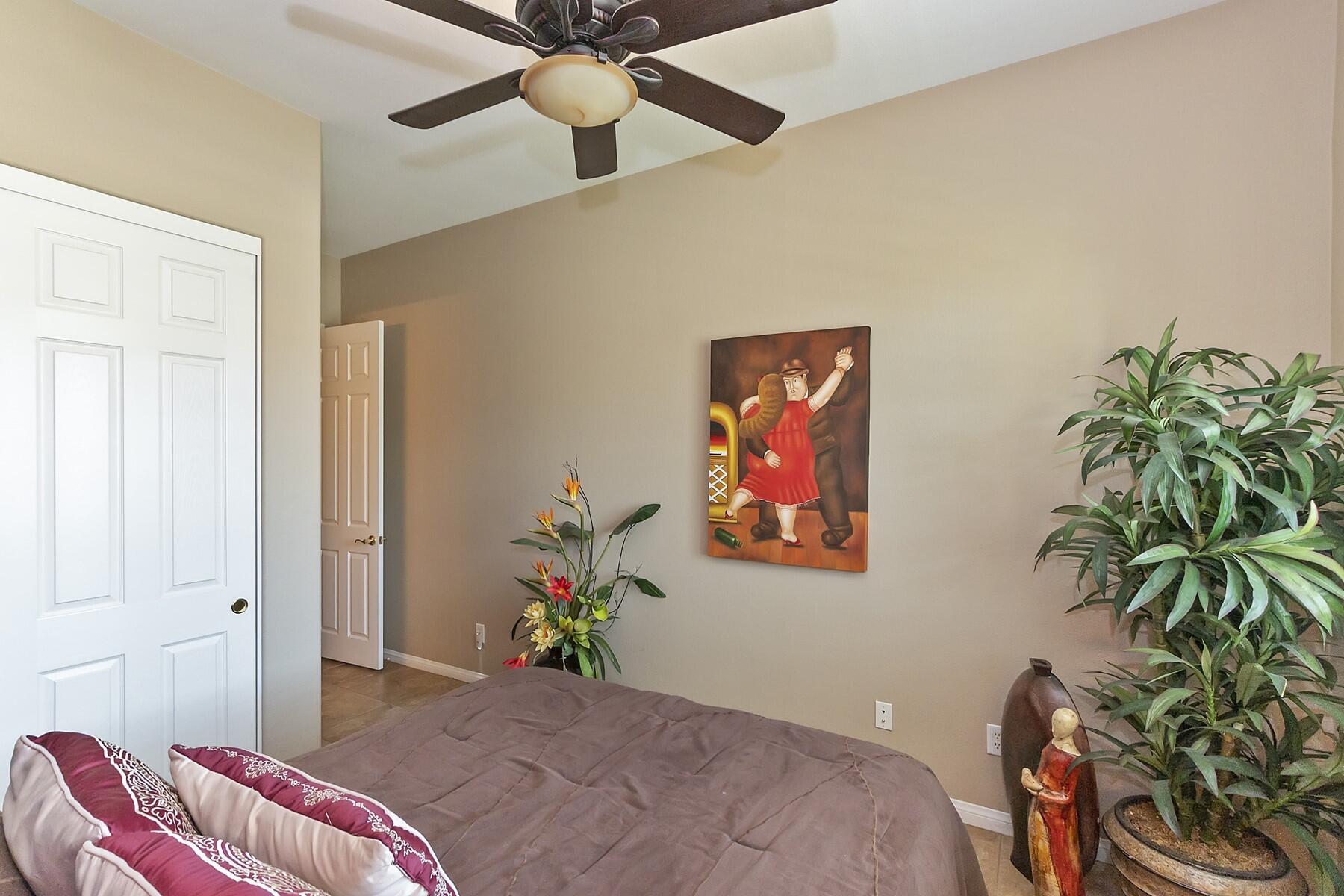 43328 Bordeaux Drive La Quinta, CA 92253 - Photo 19 of 38 a bedroom with a bed and a potted plant