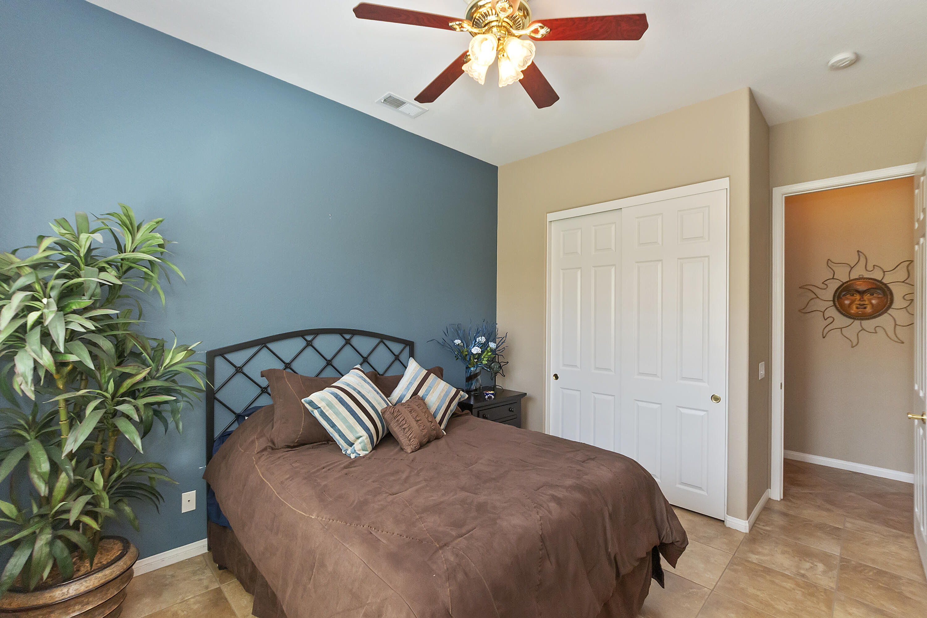 43328 Bordeaux Drive La Quinta, CA 92253 - Photo 20 of 38 a bedroom with a bed and a potted plant