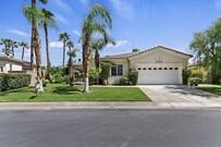 43328 Bordeaux Drive La Quinta, CA 92253 - Photo 2 of 38 a front view of a house with a yard and potted plants