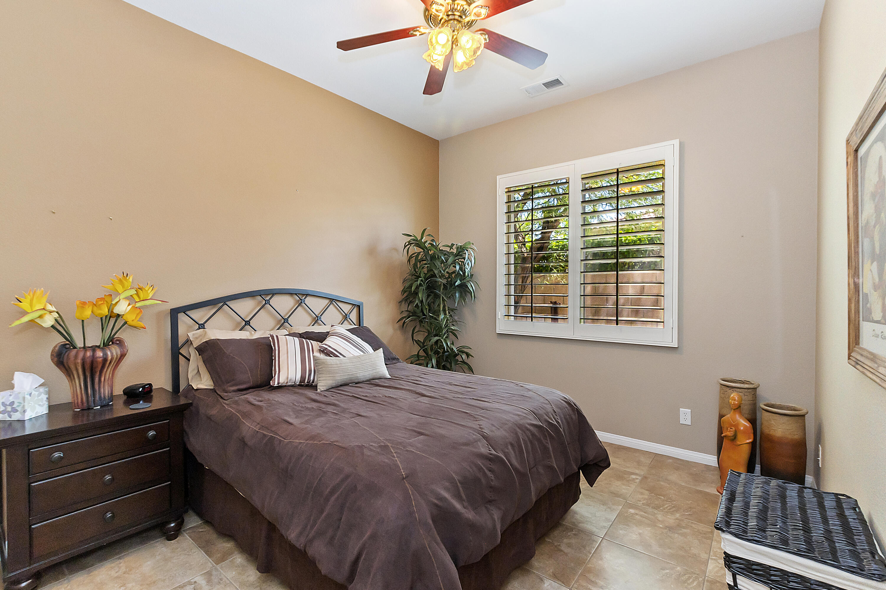 43328 Bordeaux Drive La Quinta, CA 92253 - Photo 21 of 38 a bedroom with a large bed and a chandelier