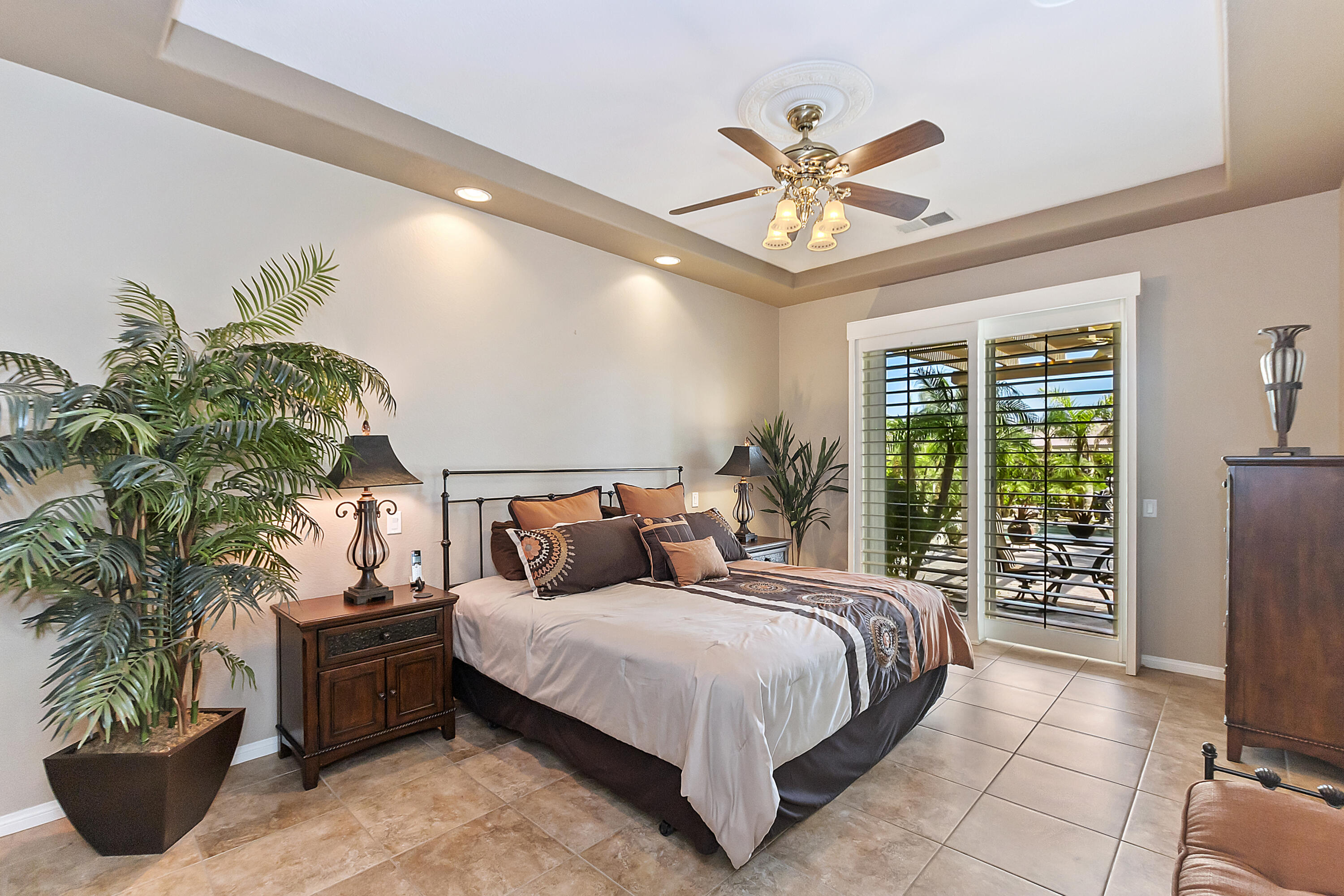 43328 Bordeaux Drive La Quinta, CA 92253 - Photo 22 of 38 a bedroom with a bed potted plant and a large window