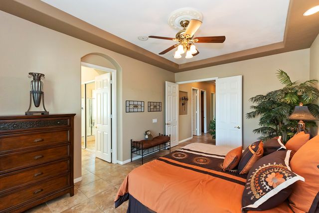 a room with furniture and ceiling fan