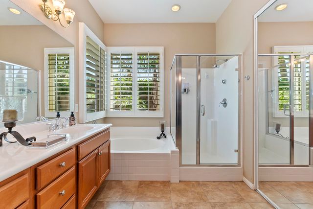 a spacious bathroom with shower tub sink and mirror