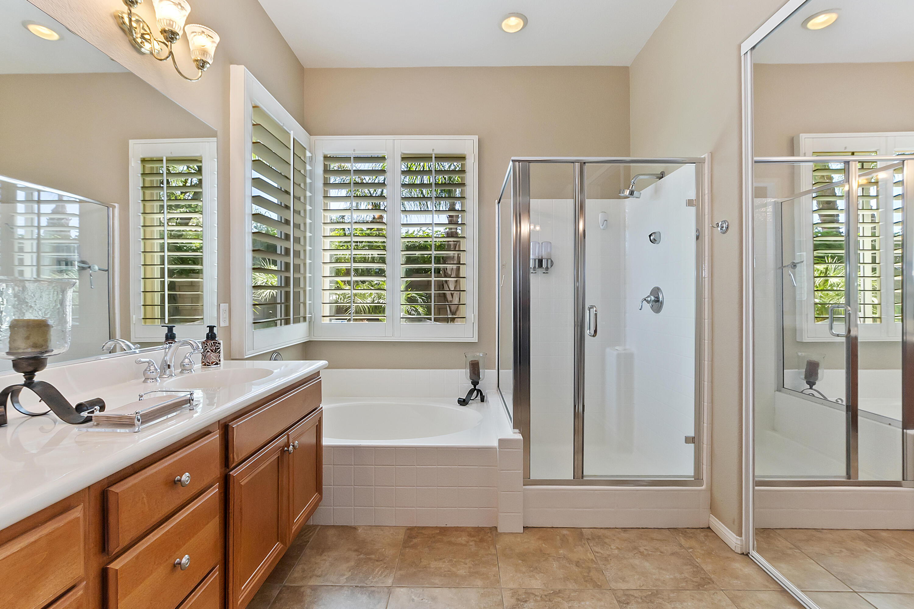 43328 Bordeaux Drive La Quinta, CA 92253 - Photo 26 of 38 a spacious bathroom with shower tub sink and mirror