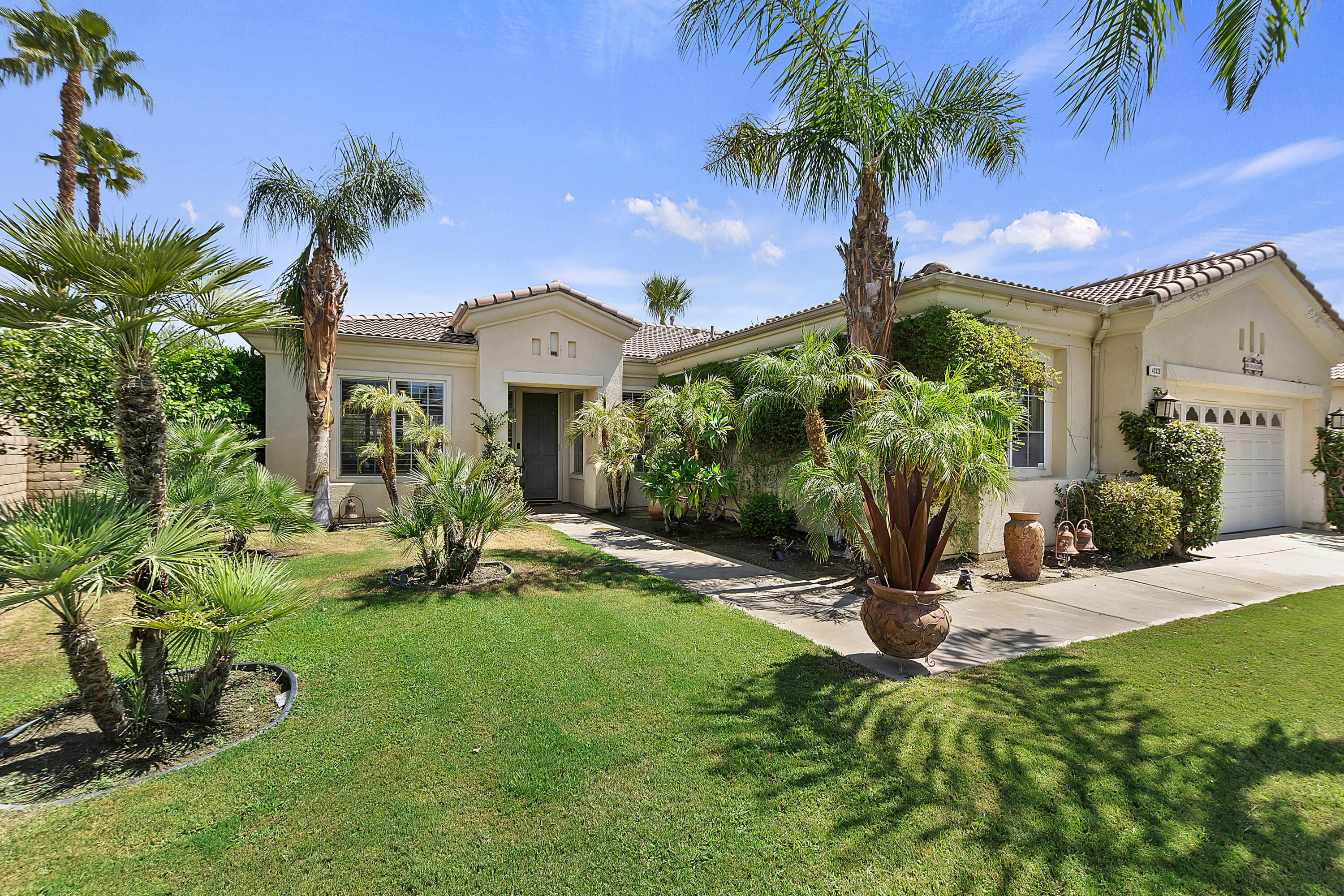 43328 Bordeaux Drive La Quinta, CA 92253 - Photo 3 of 38 a view of a house with a yard and palm trees
