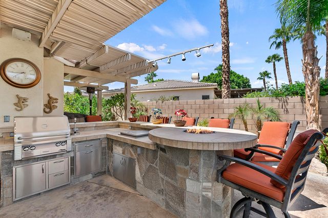 a view of a patio with table and chairs