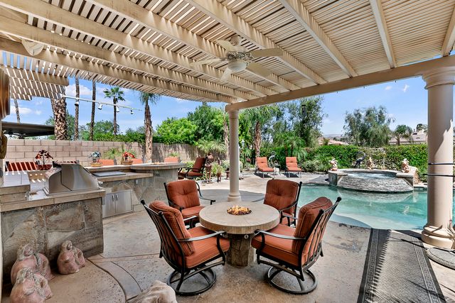 a view of a patio with couches table and chairs and potted plants