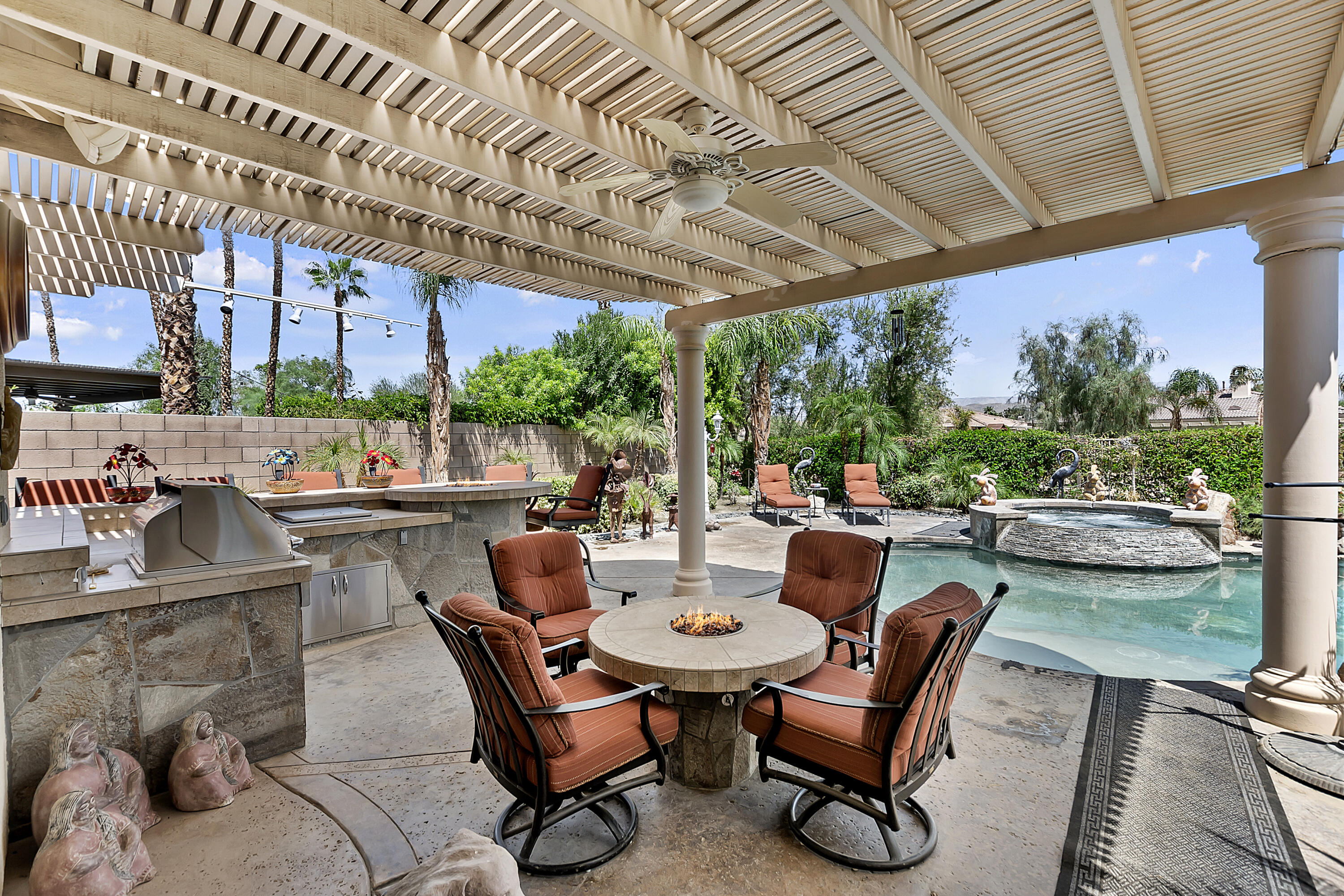 43328 Bordeaux Drive La Quinta, CA 92253 - Photo 33 of 38 a view of a patio with couches table and chairs and potted plants