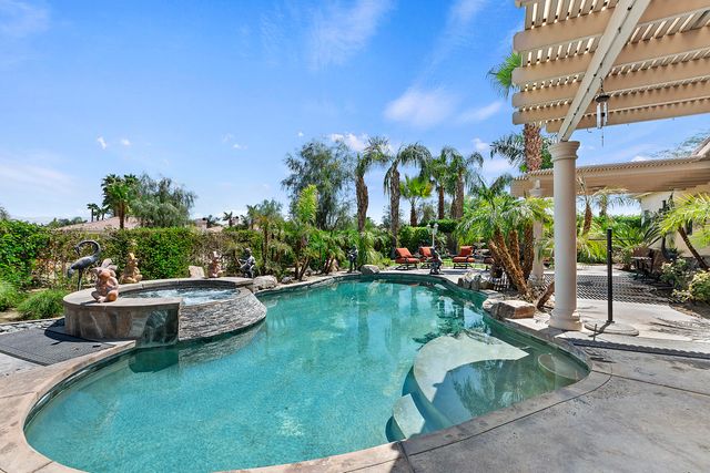 a view of a swimming pool with sitting area