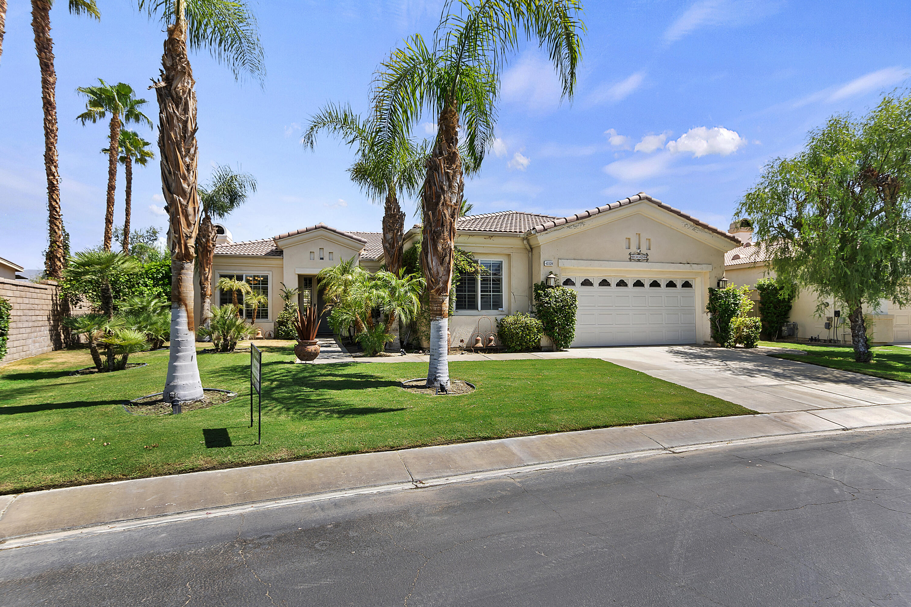 43328 Bordeaux Drive La Quinta, CA 92253 - Photo 4 of 38 a front view of a house with garden