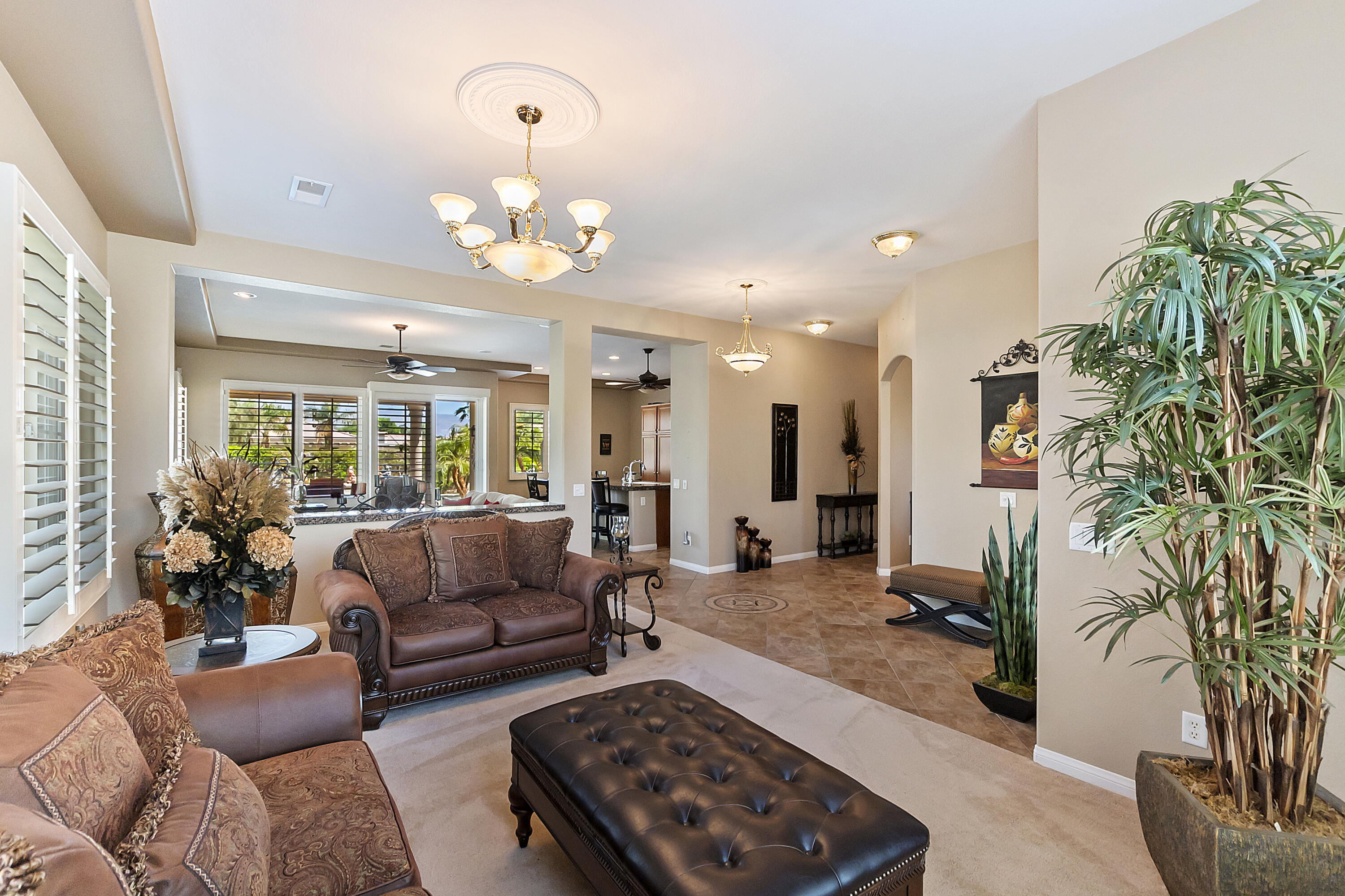 43328 Bordeaux Drive La Quinta, CA 92253 - Photo 7 of 38 a living room with furniture and a chandelier