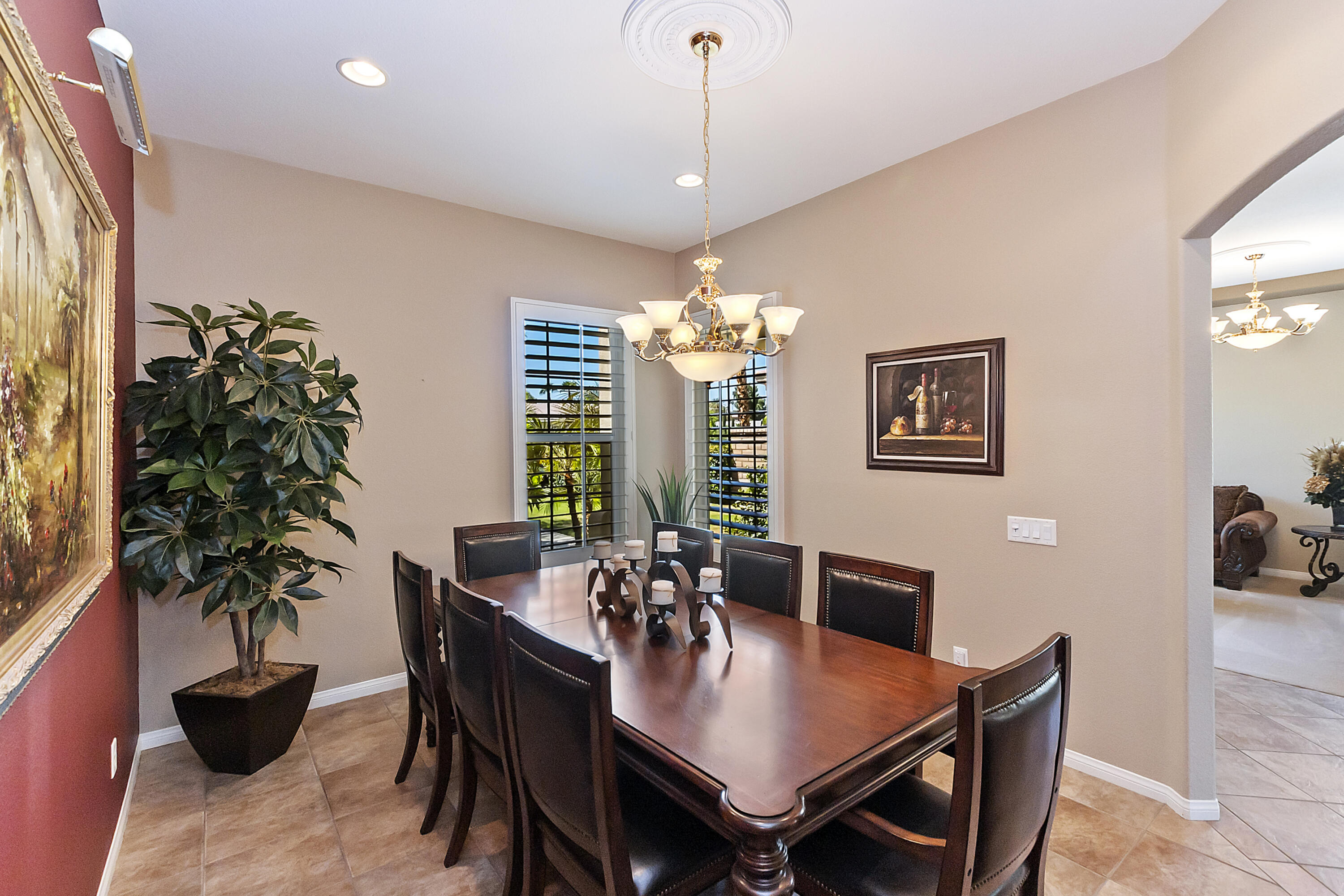 43328 Bordeaux Drive La Quinta, CA 92253 - Photo 9 of 38 a dining room with furniture potted plants and wooden floor