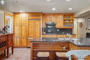 a kitchen with a refrigerator and more cabinets
