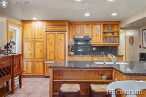 6100 Waterbarrel Road Beulah, CO 81023 - Photo 13 of 50 a kitchen with a refrigerator and more cabinets