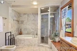 a bathroom with a tub shower and sink