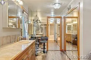 a bathroom with a granite countertop sink and a mirror