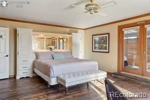 a bedroom with a bed and a chandelier