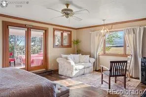 a bedroom with a bed and a large window with outer view