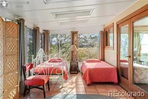 a bedroom with two beds and a large window