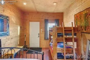 a dining room with furniture and a floor to ceiling window