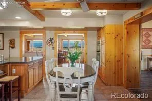 a view of a dining room with furniture and a chandelier