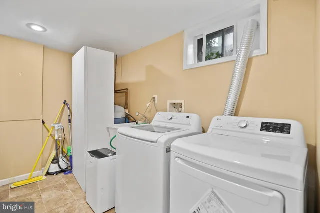 a bathroom with a toilet a sink a mirror and a shower