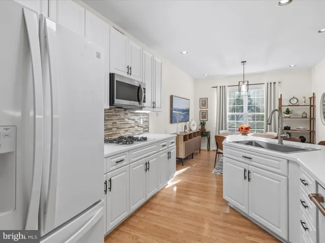 a large kitchen with a large window and stainless steel appliances