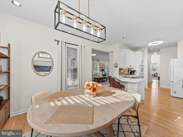 a bedroom with a bed a chandelier and a mirror