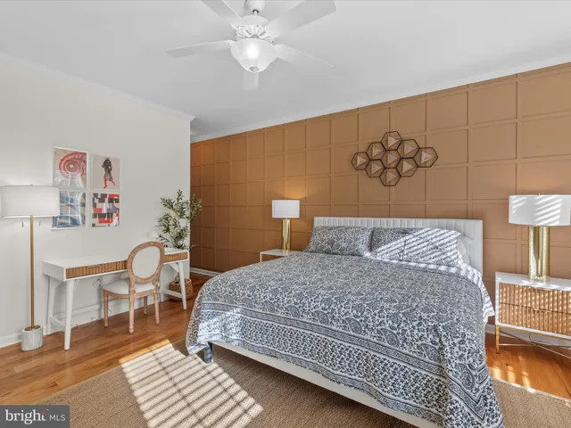 a bedroom with a bed a table and chair