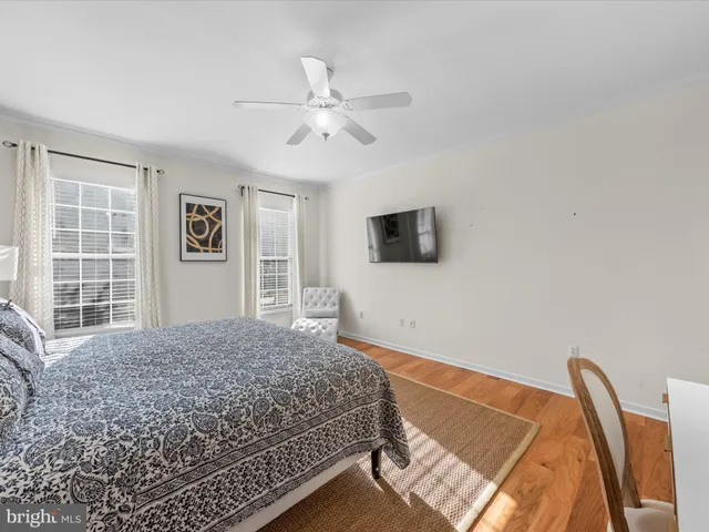 a living room with a bed furniture and a flat screen tv