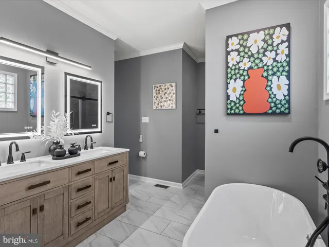 a bathroom with a double vanity sink and mirror