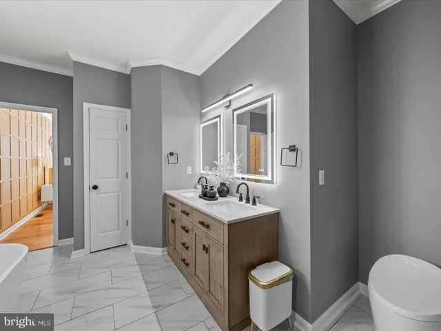 a bathroom with a toilet sink and mirror