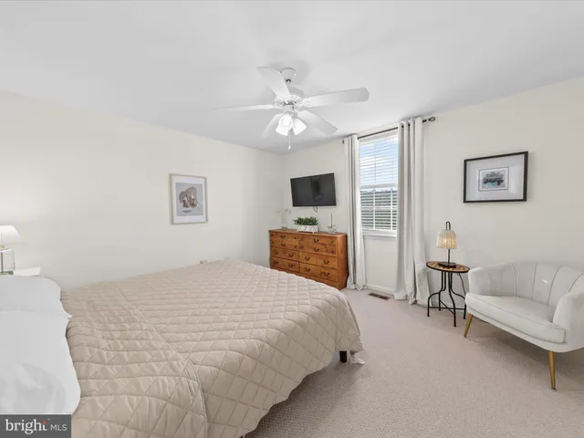 a spacious bedroom with a bed and a couch