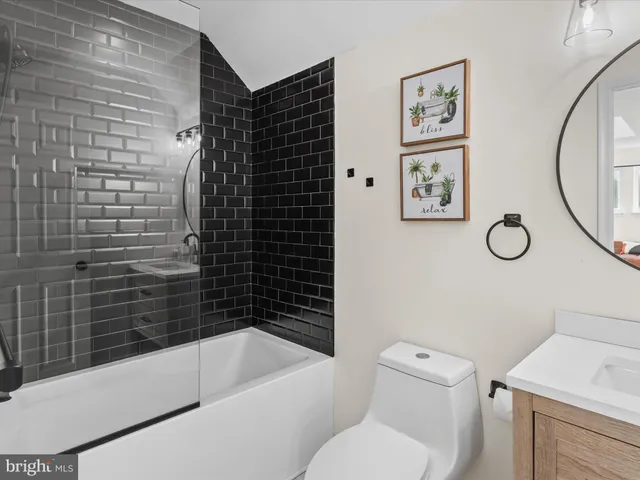 a bathroom with a toilet and a bathtub