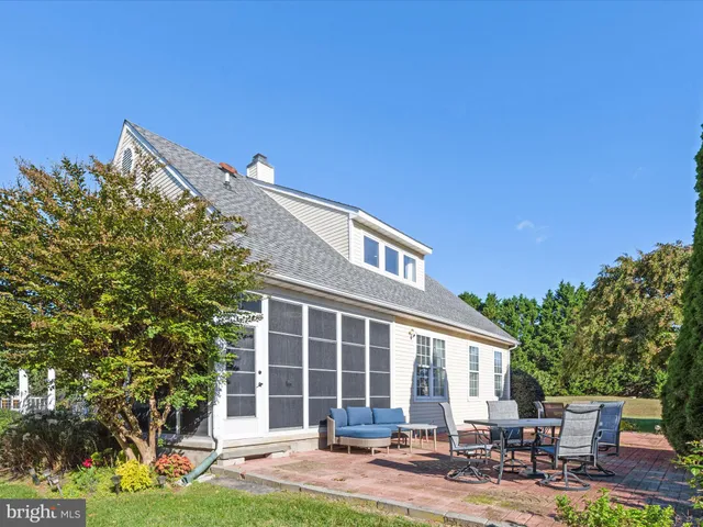 a view of a house with backyard porch and sitting area