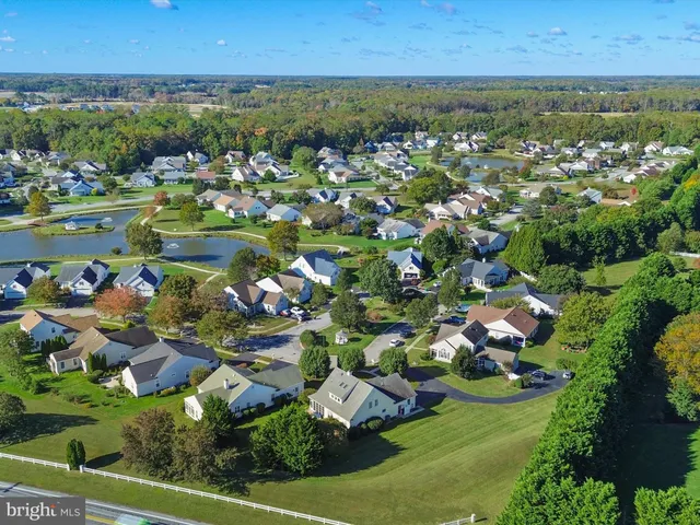an aerial view of residential houses with outdoor space and river