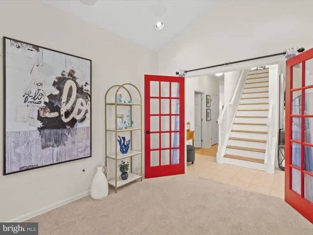 a view of an empty room with stairs and furniture