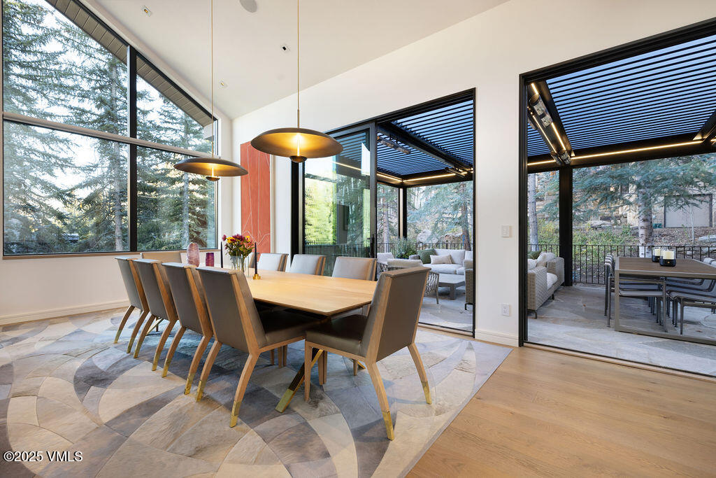 254 Beaver Dam Road Vail, CO 81657 - Photo 11 of 46 a dining room with furniture a chandelier and wooden floor