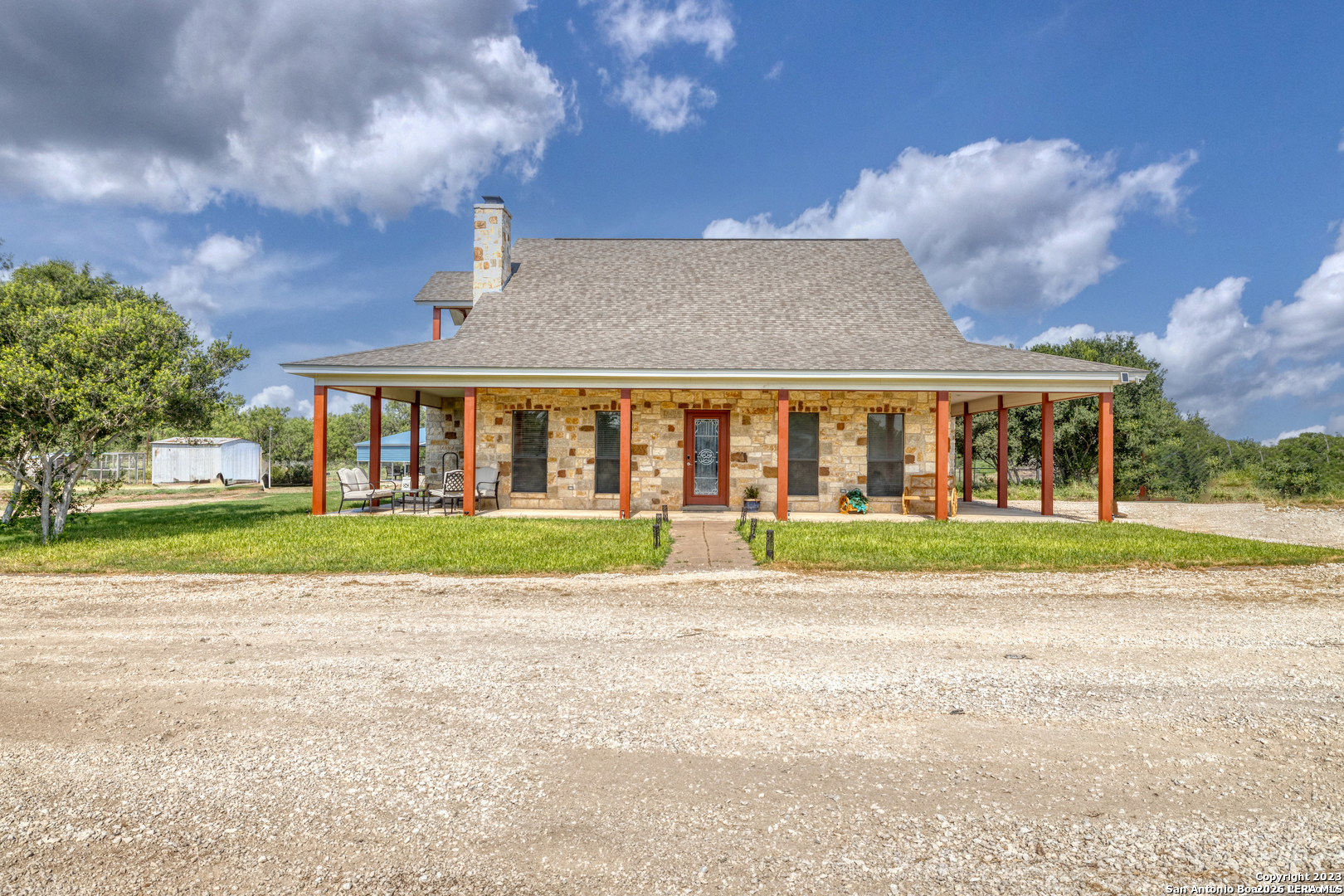 a view of brick building next to a yard