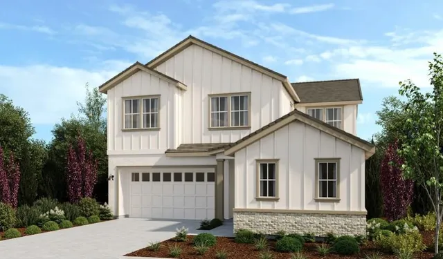 a view of a white house next to a yard