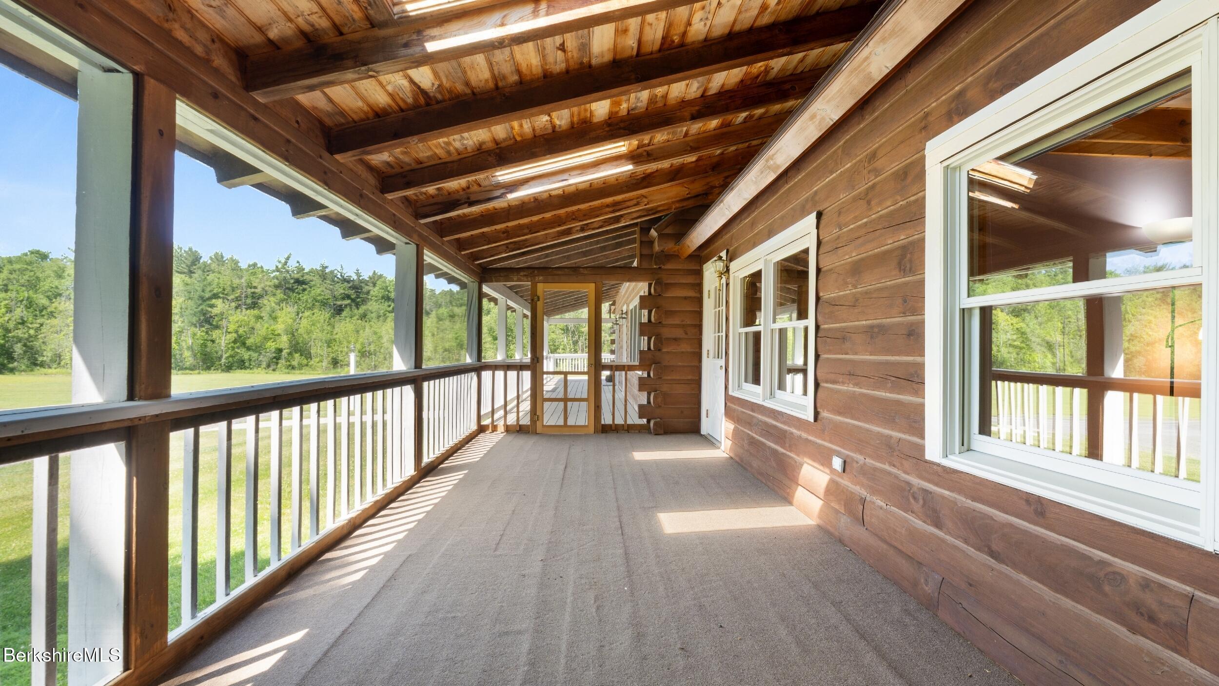 134 Hurlburt Road Great Barrington, MA 01230 - Photo 45 of 50 a view of a porch with wooden floor and stairs
