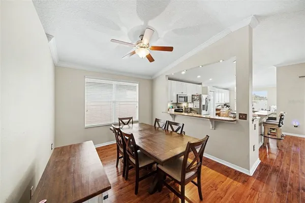 a view of a dining room with furniture and wooden floor