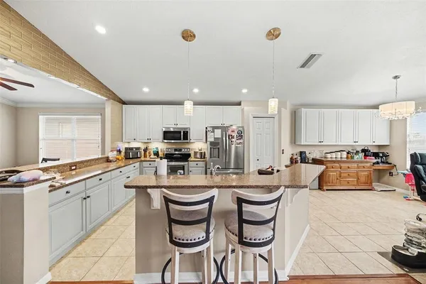 a large kitchen with a table and chairs