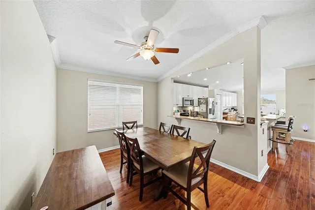 a view of a dining room with furniture and wooden floor