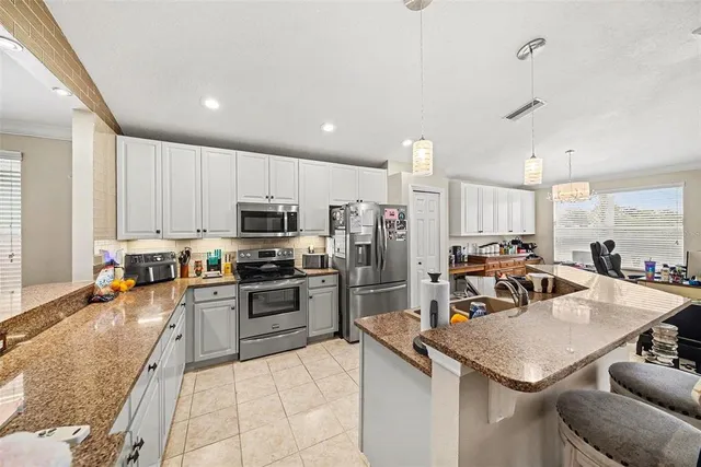 a kitchen with a sink a counter top stainless steel appliances and cabinets